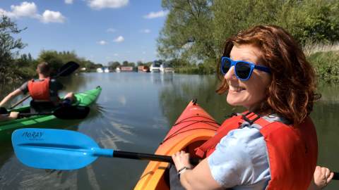 A couple kayaking on the River Thames at Lechlade with Cotswold Canoe Hire