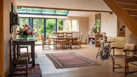 View of a large open plan dining room and living room at Kingham Cottages
