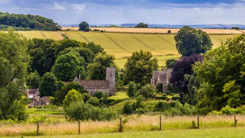 A summer view across the fields towards Asthall