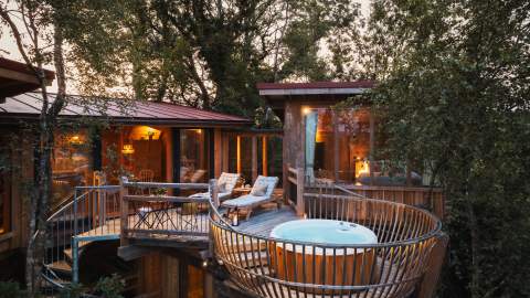 treehouse with hot tub and balcony at dusk