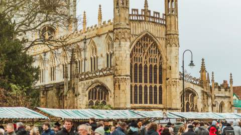 Market stalls as part of the Beverley Festival of Christmas, with St Mary's Church in the background.