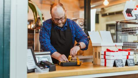 A chocolatier wrapping chocolates to sell.
