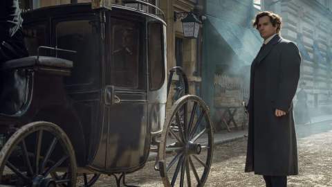 Actor Henry Cavill as Sherlock Holmes stands next to a carriage on High Street in Hull.
