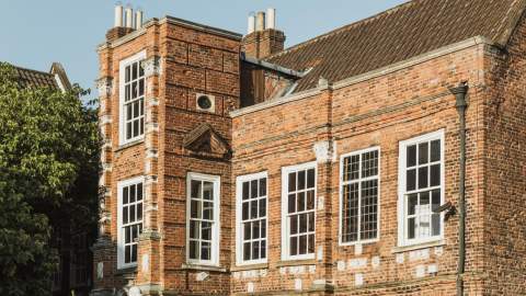 Exterior of Wilberforce House Museum in Hull’s Museums Quarter, showing its historic red‑brick Georgian architecture and large sash windows on a sunny day.