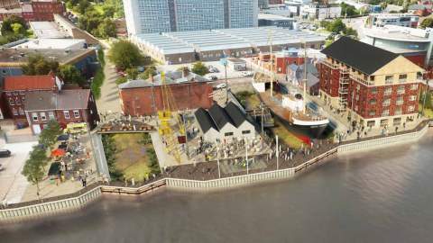 Aerial view of the North End Shipyard redevelopment in Hull, showing restored historic buildings, the Spurn Lightship, waterfront walkways, cranes, and visitors exploring the newly designed heritage site alongside the River Hull.