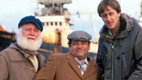 A still from the 'to Hull and Back' Christmas episode of Only Fools and Horses. Characters Del Boy, Rodney and Grandad stand in front of a ship.