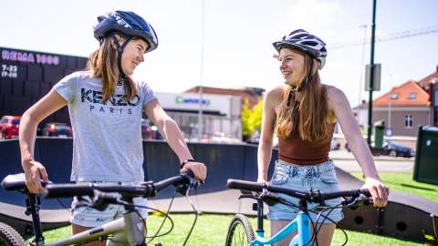 Two girls with bicycles