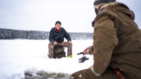Two sitting and fishing on the ice