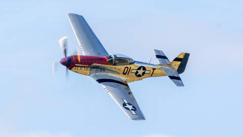 Image shows P-51 Mustang aircraft in sky