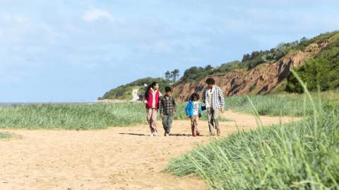 A family walk along the beach in Wirral