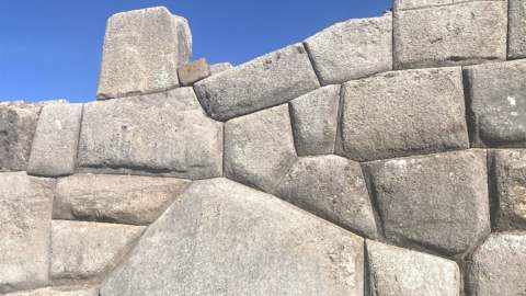 An art installation showing rocks against a blue sky