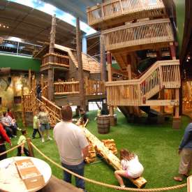 Parents watch the children enjoying the indoor play space at the Science Museum Oklahoma.