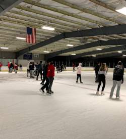 People ice skating in an indoor ice skating rink in the Lehigh Valley