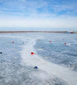Red and blue markers placed on a frozen Presque Isle Bay in Erie