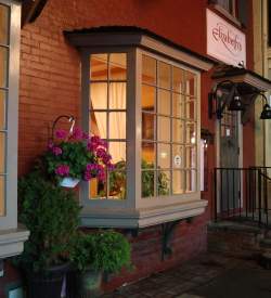Exterior of a storefront at night on a main street that reads Elizabeth's