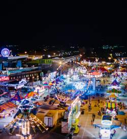 Aerial view of York State Fair at night with glowing rides