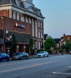 Downtown main street with quaint shops and buildings, and a vibrant, old school movie theater sign that reads Indiana