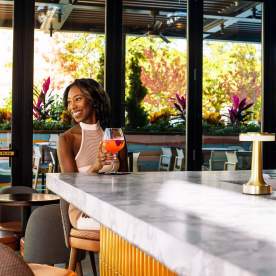 Woman enjoying a Cocktail at the Paloma Bar