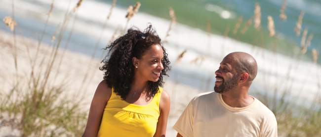 Couple enjoying a walk on the beach