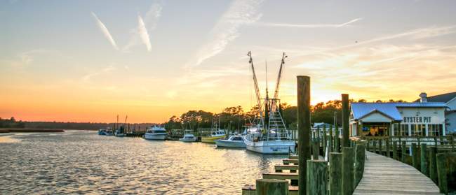 Calabash, NC waterfront with boats along the dock at sunset