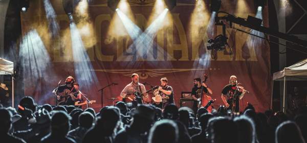 Zach Bryan and his band play on the Peacemaker Festival main stage.