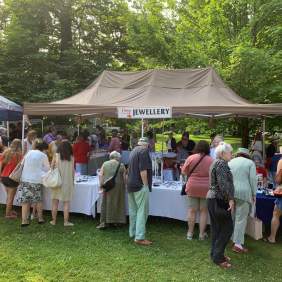 Crowd gathered around hand crafted jewellery vendor booth