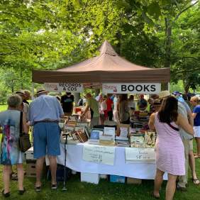 Crowd gathered around book sale vendor booth