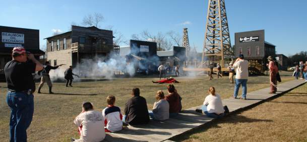 Spindletop history as actors portray a shootout at the anniversary celebration.