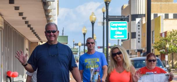 A group of people enjoying touring the geocaching attractions in downtown Beaumont.