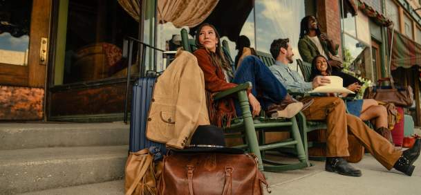 Friends exploring local boutiques and shops on a lively downtown Wyoming main street, framed by classic Western architecture.