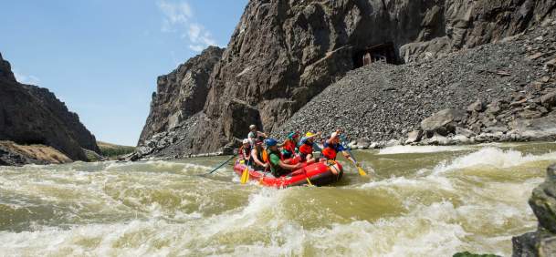 Group of people rafting through whitewater rapids on a river in Fremont County, near Thermopolis, Wyoming.