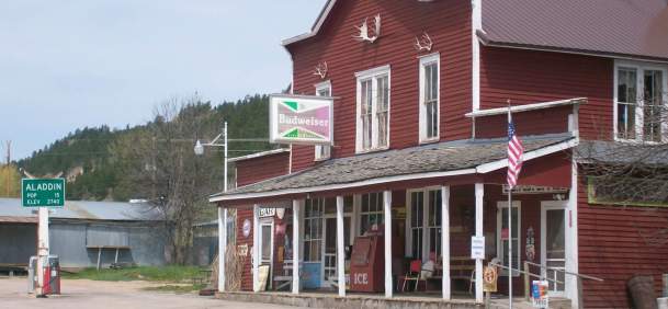 Historic Aladdin General Store and gas station with vintage signage in Crook County, Wyoming.