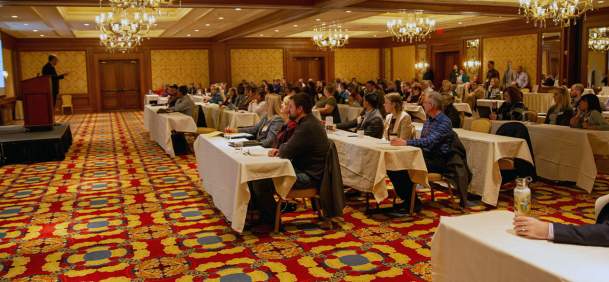 Conference attendees listening to a presentor