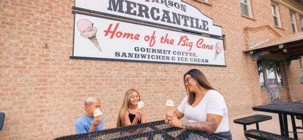 Exterior building of Farson Mercantile with family enjoying ice cream at picnic tables.