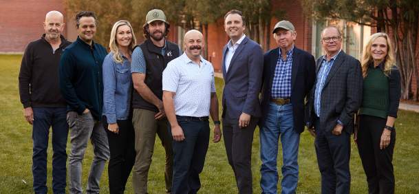 Board members standing gathered