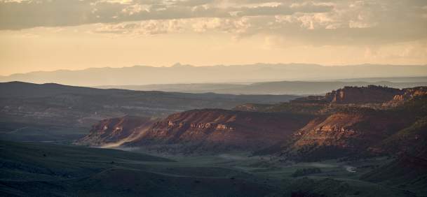 Large sweeping landscape with prairie and red dirt