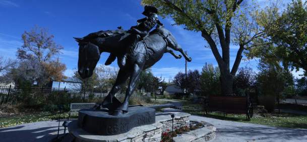 Bronze statue of Chris LeDoux riding a horse in Kaycee, Johnson County, Wyoming.