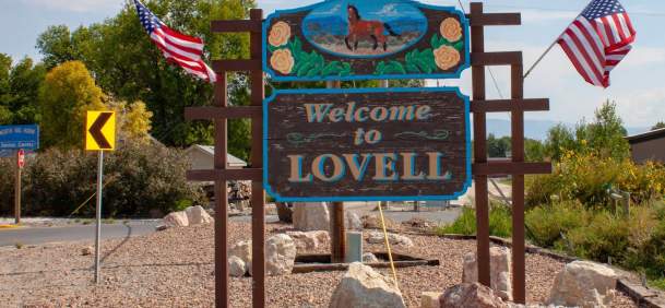 Welcome sign for Lovell, Wyoming, surrounded by scenery in Big Horn County.