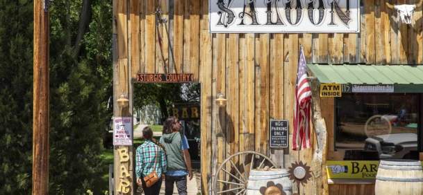 Tourists observing quirky saloon attraction in Hulett, in Crook County, Wyoming.