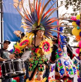 Performer in traditional attire dancing during Denison’s Dia de los Muertos celebration
