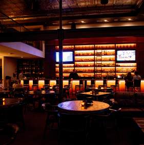 Interior view of Doc’s Lounge featuring seating, drinks, and live music atmosphere