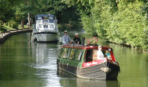 barge and cruiser on the thames