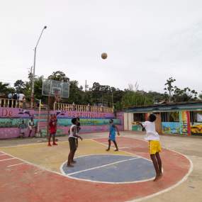 Group playing on a basketball rural court
