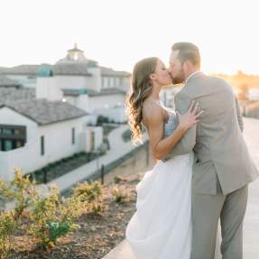 A bride and groom kiss outside Europe Village