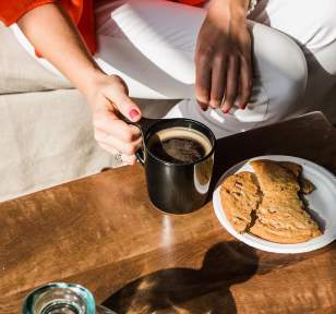 Coffee being enjoyed with a large cookie
