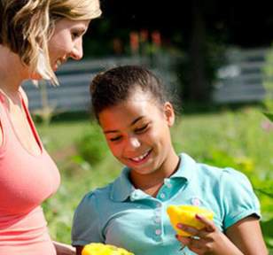 Woman and Child Eating Fruit
