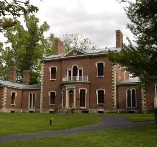 Ashland, The Henry Clay Estate is a red brick mansion with large white stone on the corners of the house and white detailing around the windows.