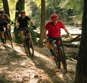 3 cyclists on a bike trail