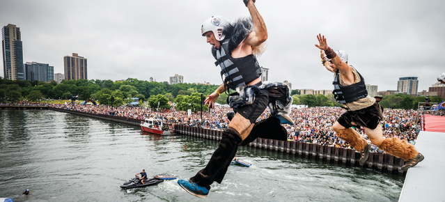people dressed in costume jumping into the lake