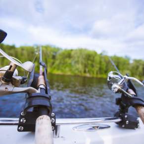 Two fishing poles sitting in the boat